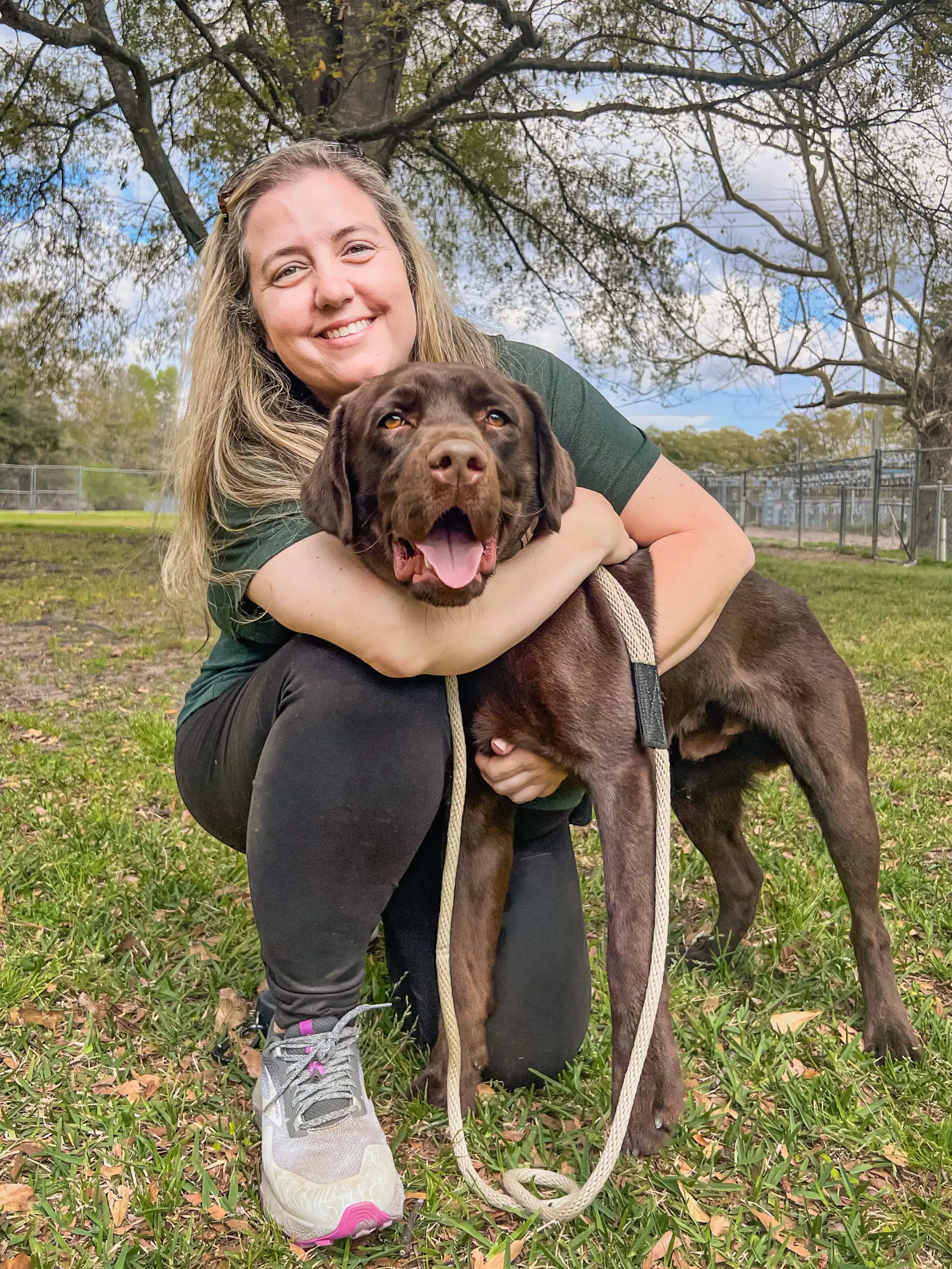Janie, co-owner of Chucktown Charley, outdoors with her chocolate Labrador